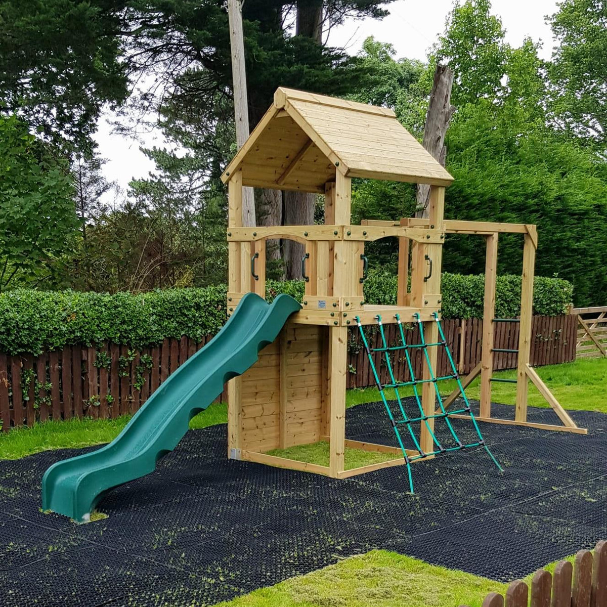 Goodrich Tower with slide, climbing wall, net and monkey bars. INSTALLED