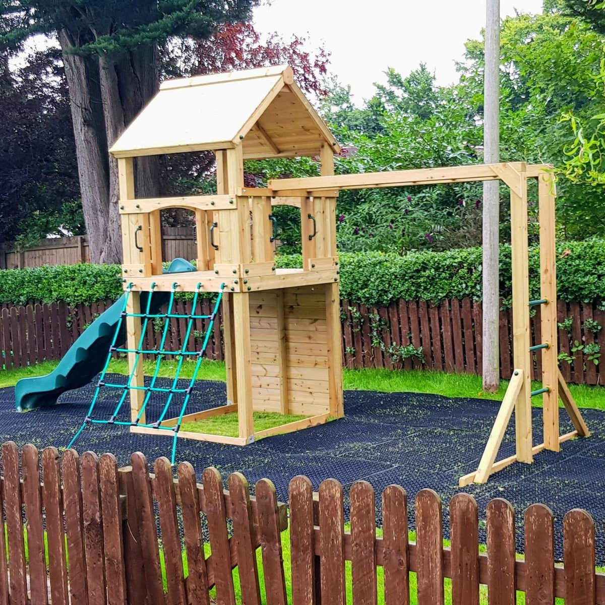 Goodrich Tower with slide, climbing wall, net and monkey bars. INSTALLED