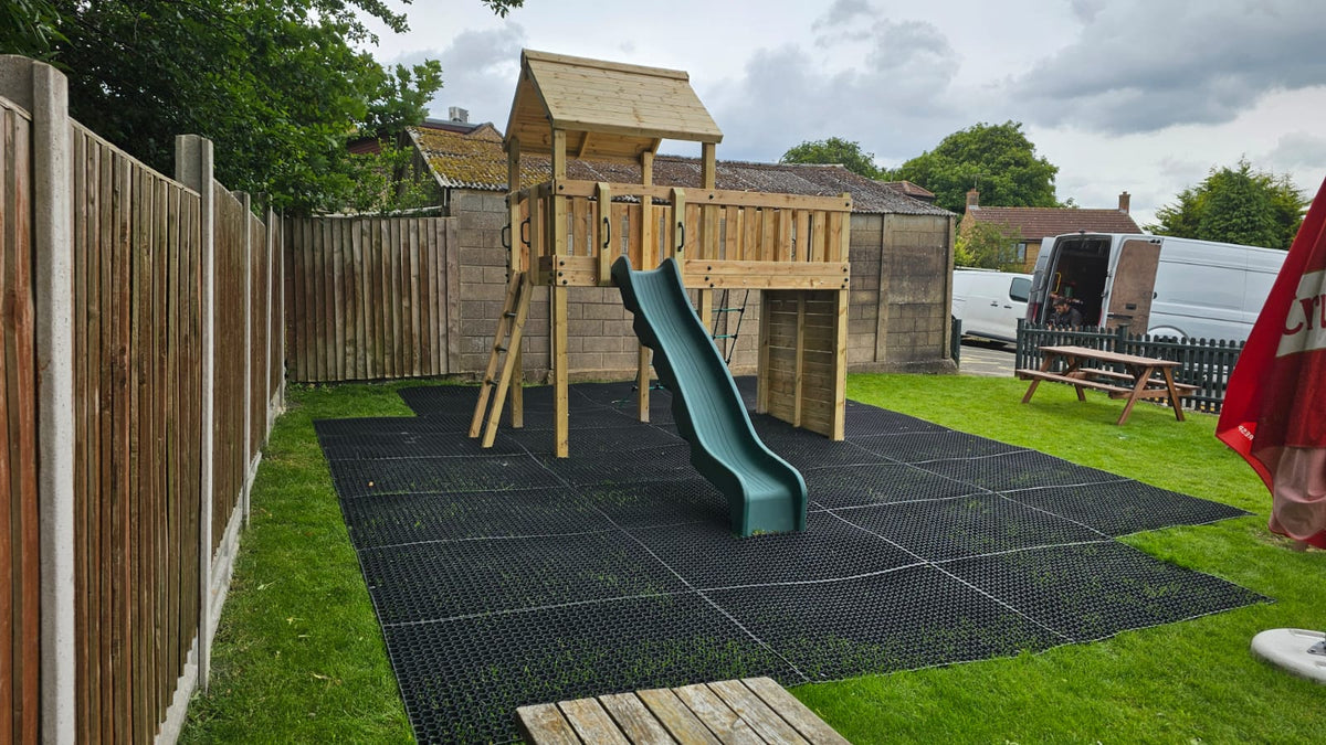 Eastnor Play Tower with ladder, climbing wall, net, and slide. INSTALLED