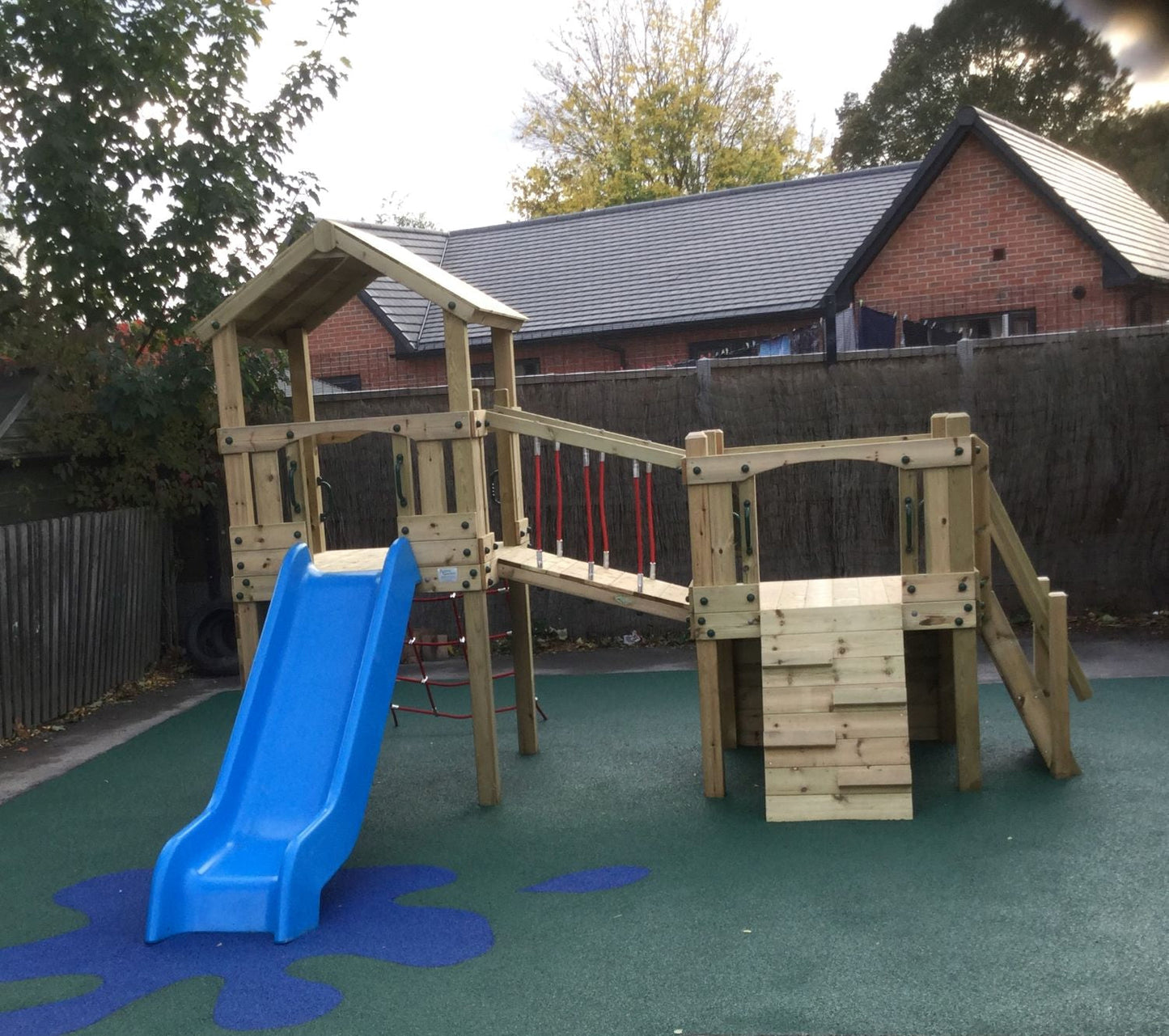 Croft Towers with slide, ladder, climbing walls, net, left-right climber and bridge. INSTALLED