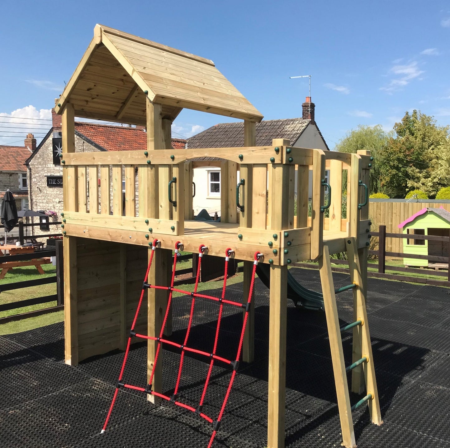Eastnor Play Tower with ladder, climbing wall, net, and slide. INSTALLED
