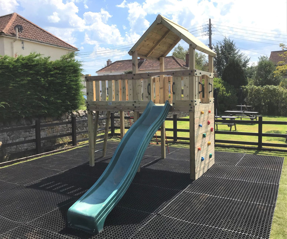 Eastnor Play Tower with ladder, climbing wall, net, and slide. INSTALLED