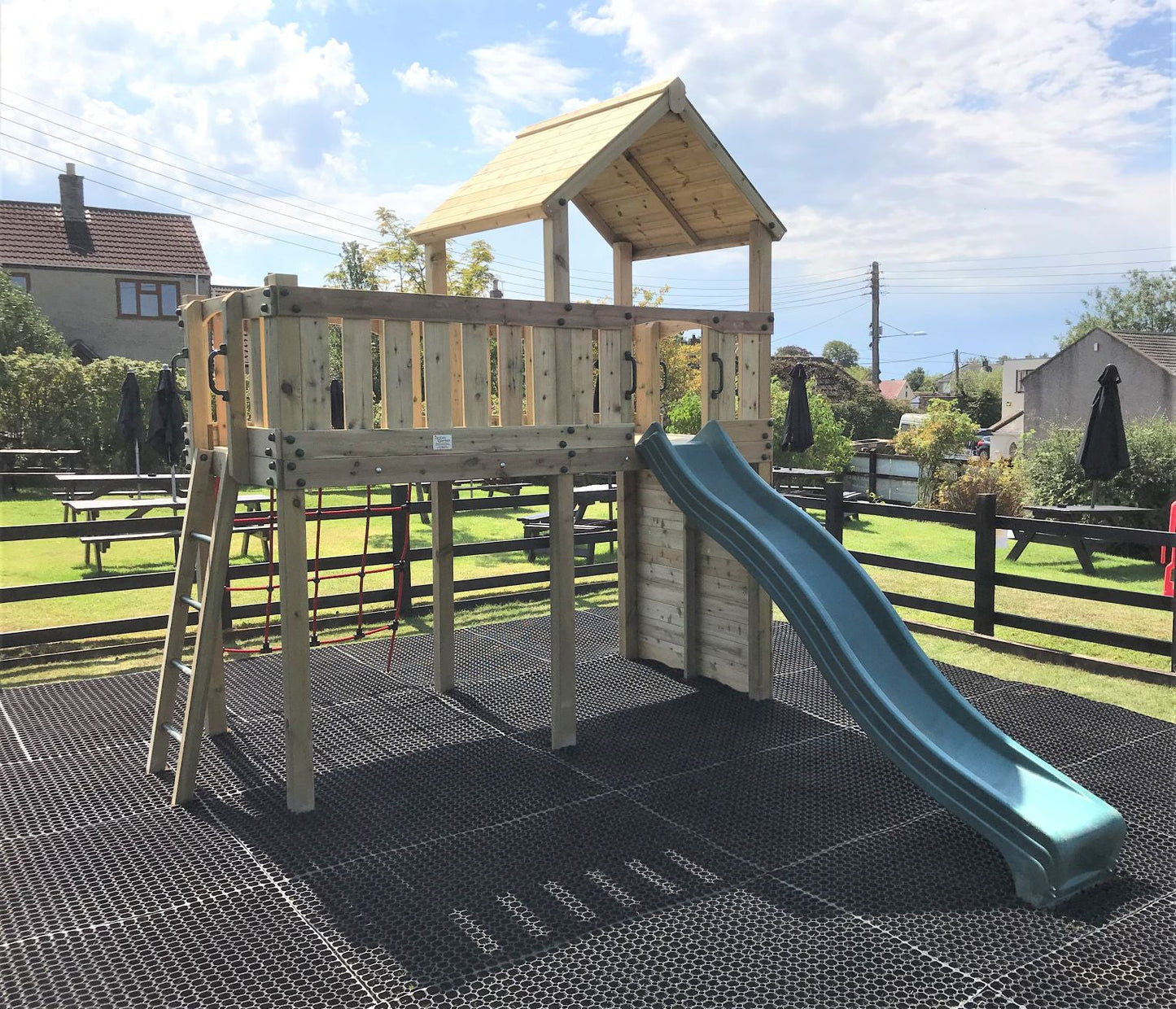 Eastnor Play Tower with ladder, climbing wall, net, and slide. INSTALLED